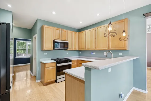 a kitchen with a sink a stove and cabinets
