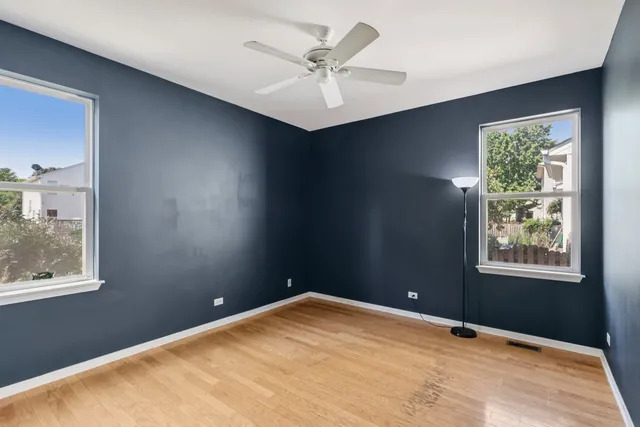 a view of a room with a ceiling fan and a window