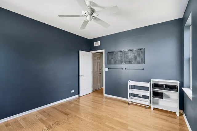 a view of kitchen with wooden floor and ceiling fan