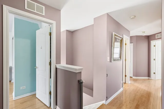 a view of hallway with wooden floor