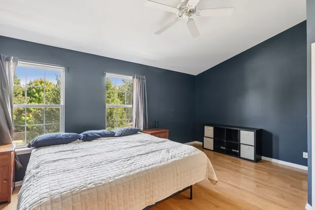 a bedroom with a large bed and a window
