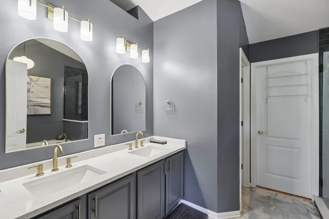 a bathroom with a double vanity sink and a mirror