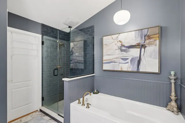 a bathroom with a bathtub and a shower