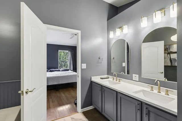 a bathroom with a double vanity sink and a mirror