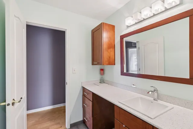 a bathroom with a sink vanity and mirror