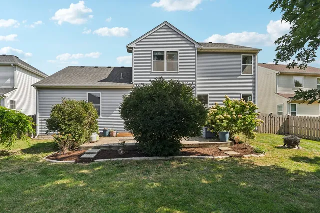 a view of a house with backyard and sitting area