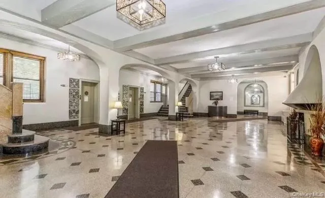 a lobby with a couch and a chandelier