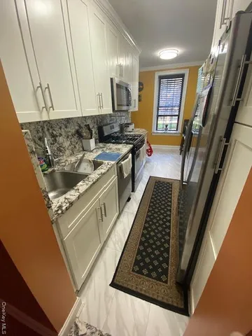 a kitchen with a stove and white cabinets