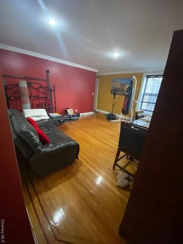a room with gym equipment and a wooden floor