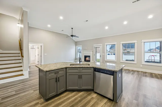 a kitchen with granite countertop a sink and cabinets
