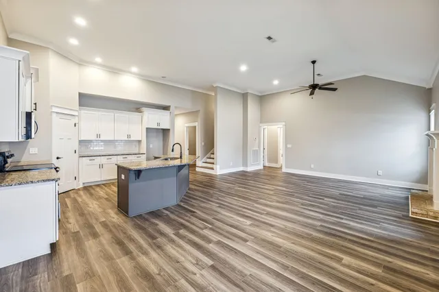 a view of kitchen with stainless steel appliances granite countertop counter space a sink refrigerator and cabinets