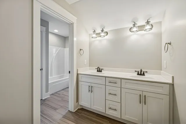 a bathroom with a double vanity sink and mirror