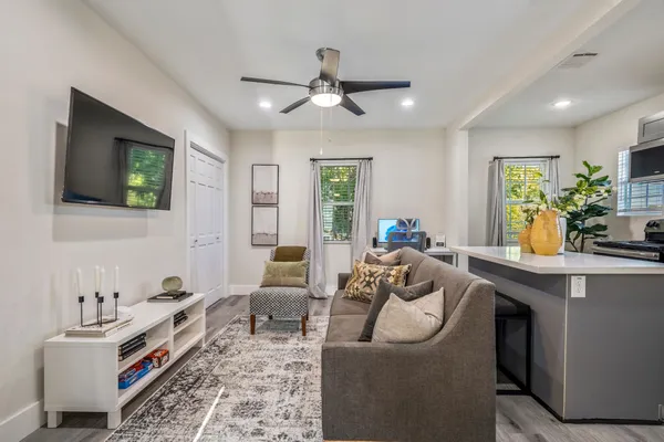 a living room with furniture and a chandelier