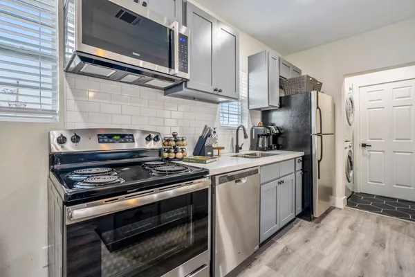 a kitchen with stainless steel appliances a stove and a refrigerator