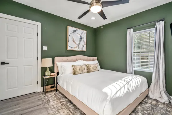 a bedroom with a bed and a chandelier