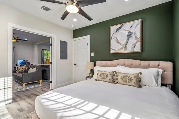 a bedroom with a bed and a chandelier