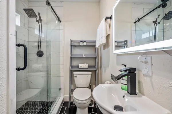 a bathroom with a sink toilet and shower