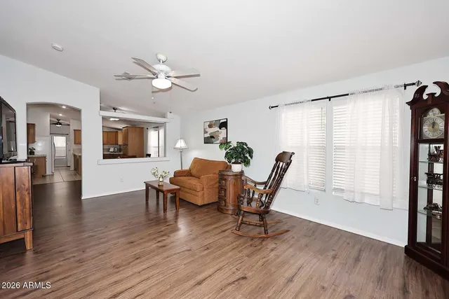 a living room with furniture and a wooden floor