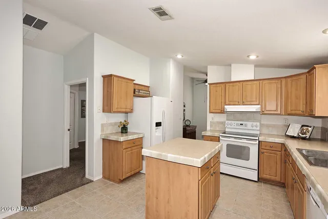 a kitchen with a sink stove and refrigerator