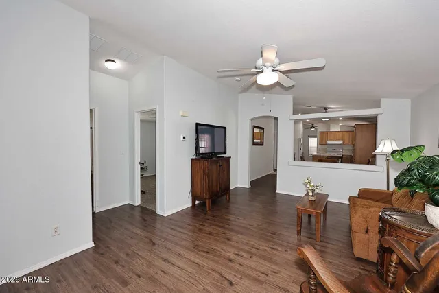 a living room with furniture and a wooden floor