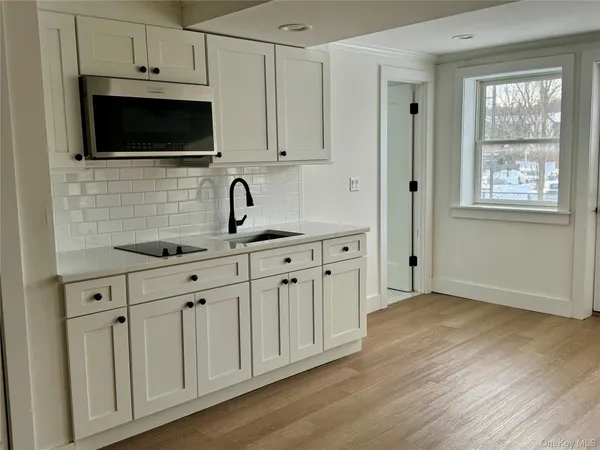 a view of a kitchen with electric appliances