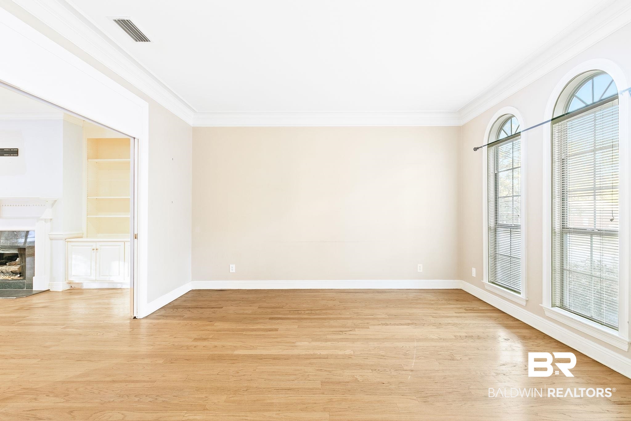 2100 Stonebrook Drive West Mobile, AL 36695 - Photo 13 of 60 Unfurnished room featuring a premium fireplace, crown molding, and light hardwood / wood-style flooring