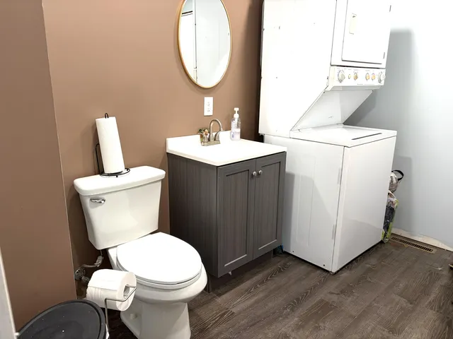 a bathroom with a toilet sink and mirror