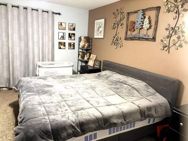 a bedroom with a bed and a window