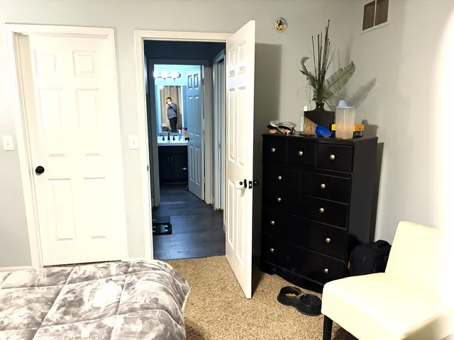 a bedroom with a bed and a dresser