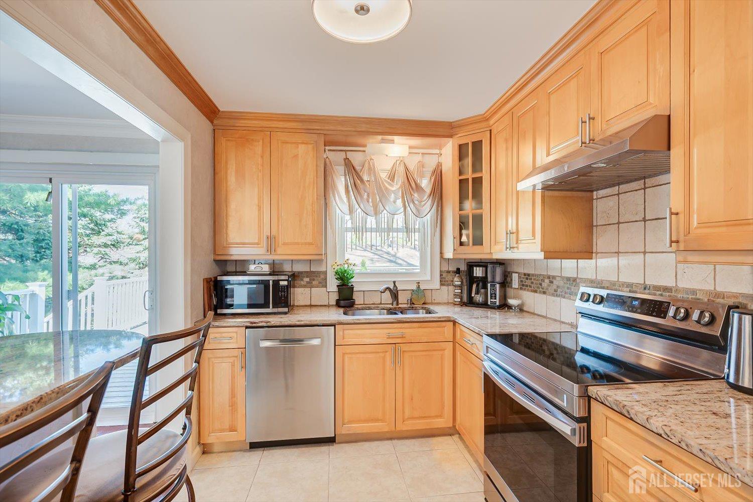 71 Crosby Avenue Edison, NJ 08817 - Photo 11 of 40 a kitchen with a sink stove and cabinets