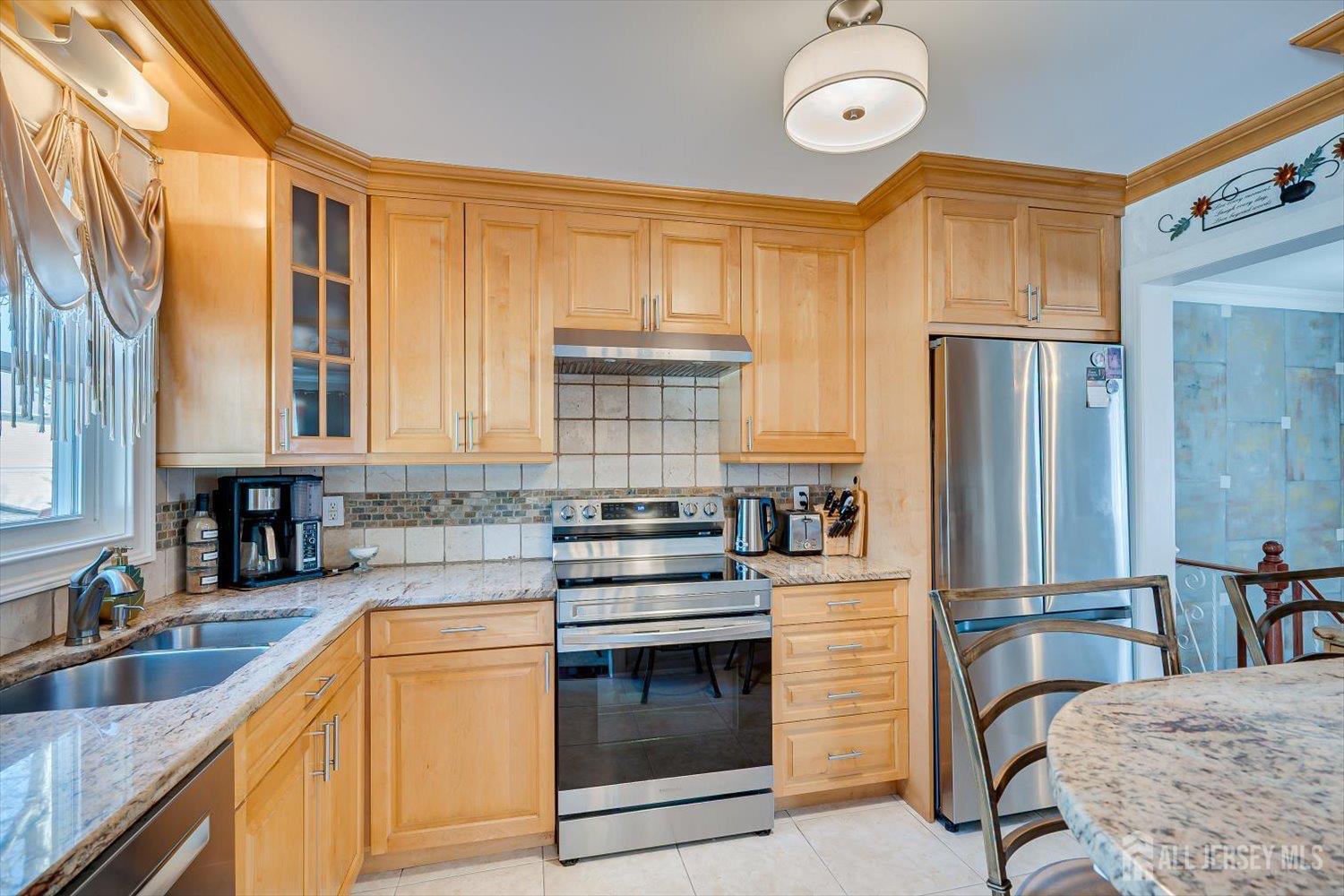 71 Crosby Avenue Edison, NJ 08817 - Photo 12 of 40 a kitchen with stainless steel appliances granite countertop a stove and a sink