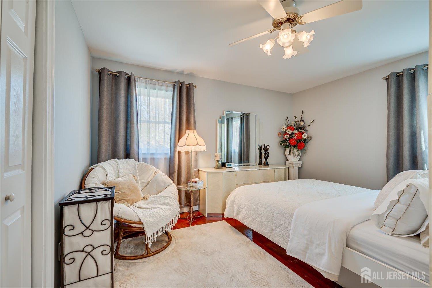 71 Crosby Avenue Edison, NJ 08817 - Photo 14 of 40 a bedroom with a bed and a chandelier