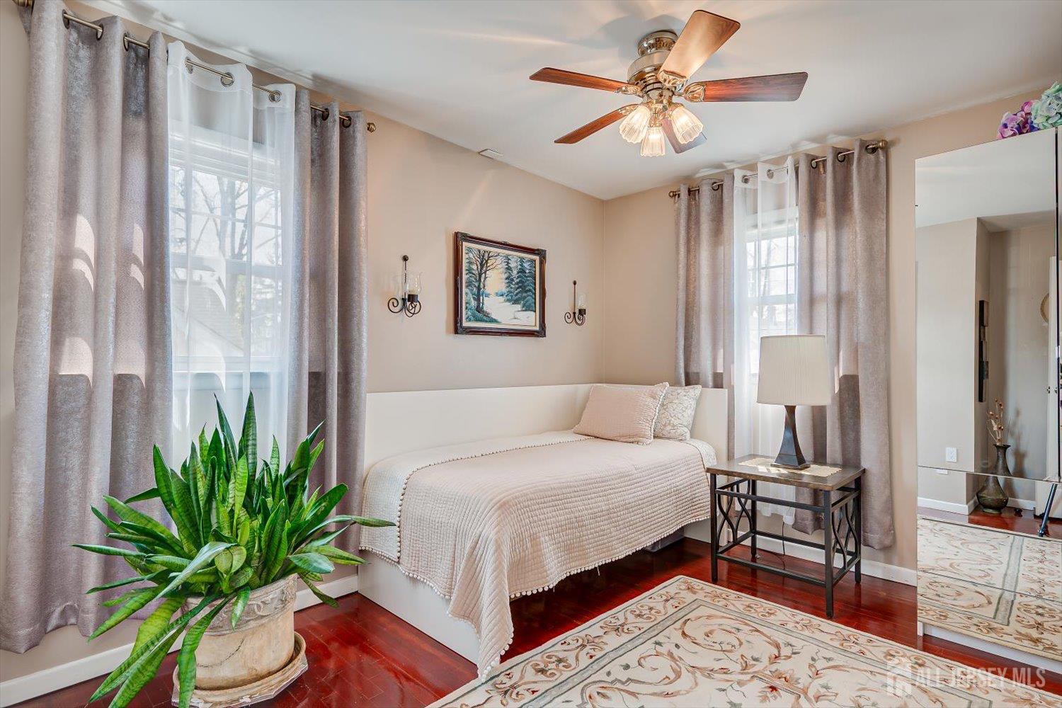 71 Crosby Avenue Edison, NJ 08817 - Photo 17 of 40 a bedroom with a large bed and a chandelier