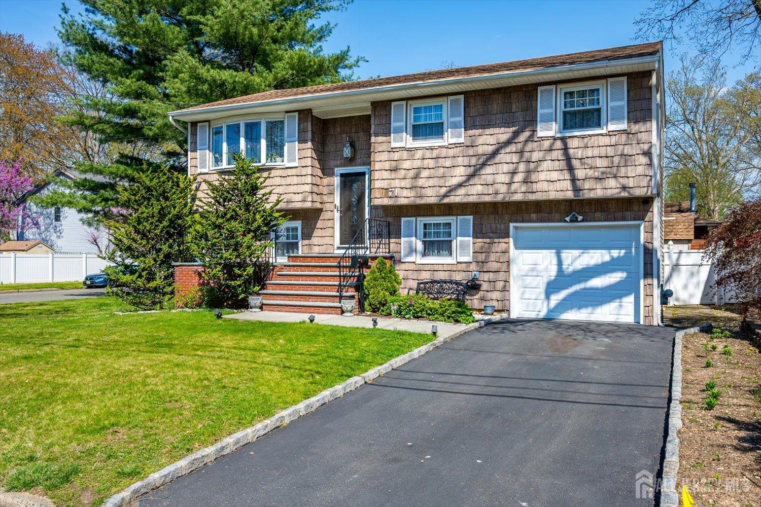 71 Crosby Avenue Edison, NJ 08817 - Photo 2 of 40 a front view of a house with a garden and yard
