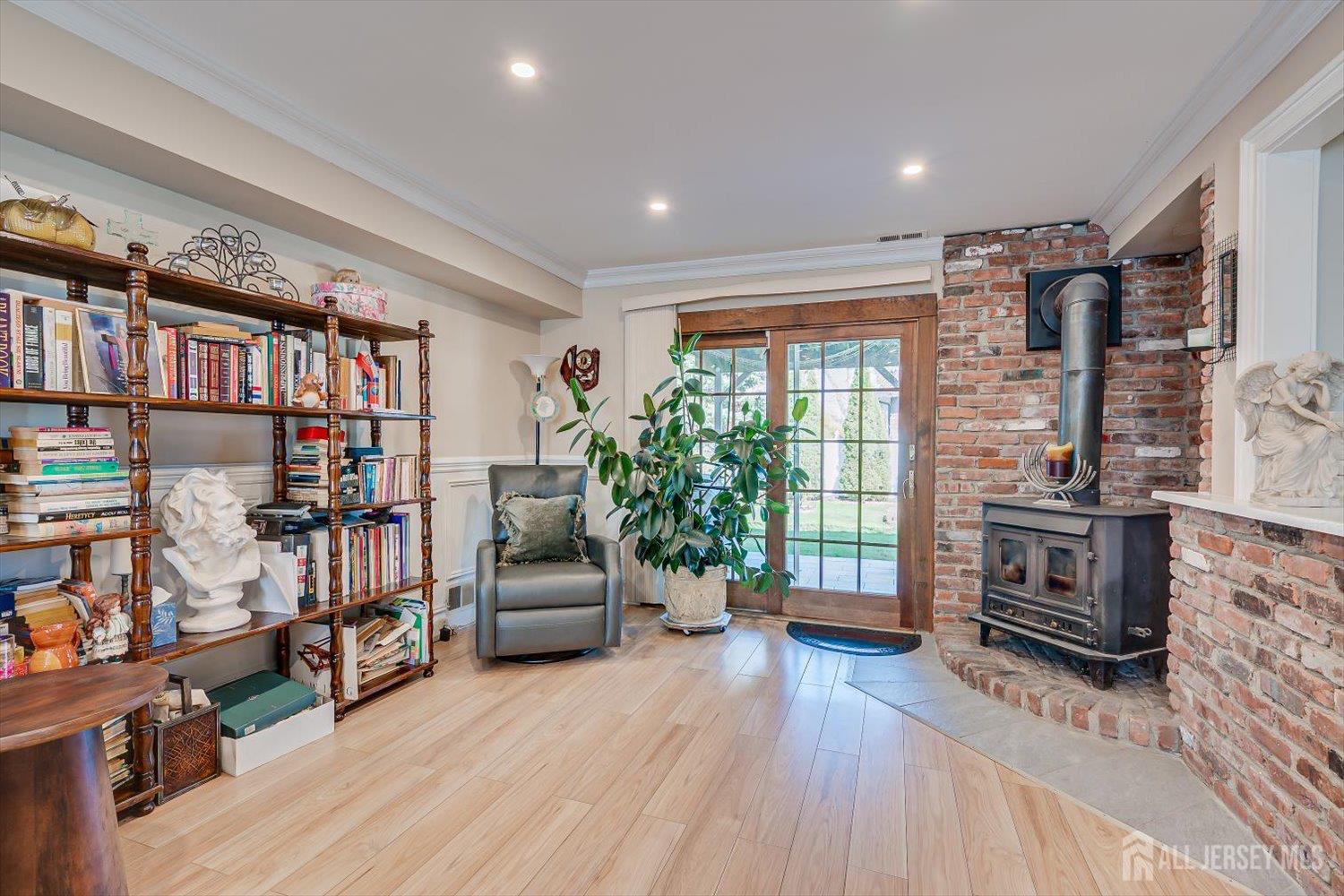 71 Crosby Avenue Edison, NJ 08817 - Photo 26 of 40 a living room with furniture a flat screen tv and a book shelf