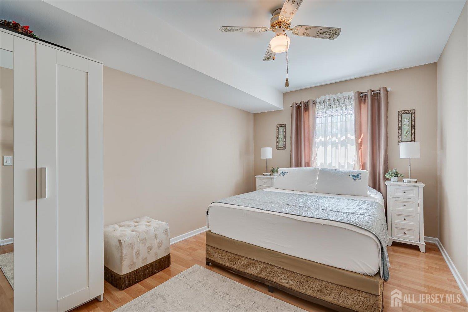 71 Crosby Avenue Edison, NJ 08817 - Photo 27 of 40 a bedroom with a bed and a chandelier