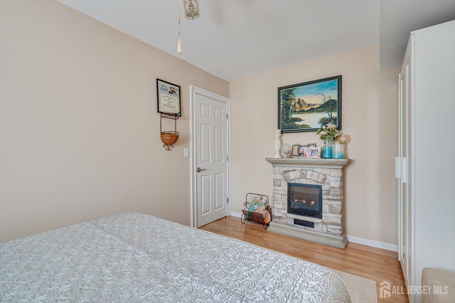 71 Crosby Avenue Edison, NJ 08817 - Photo 28 of 40 a bedroom with furniture and a fireplace