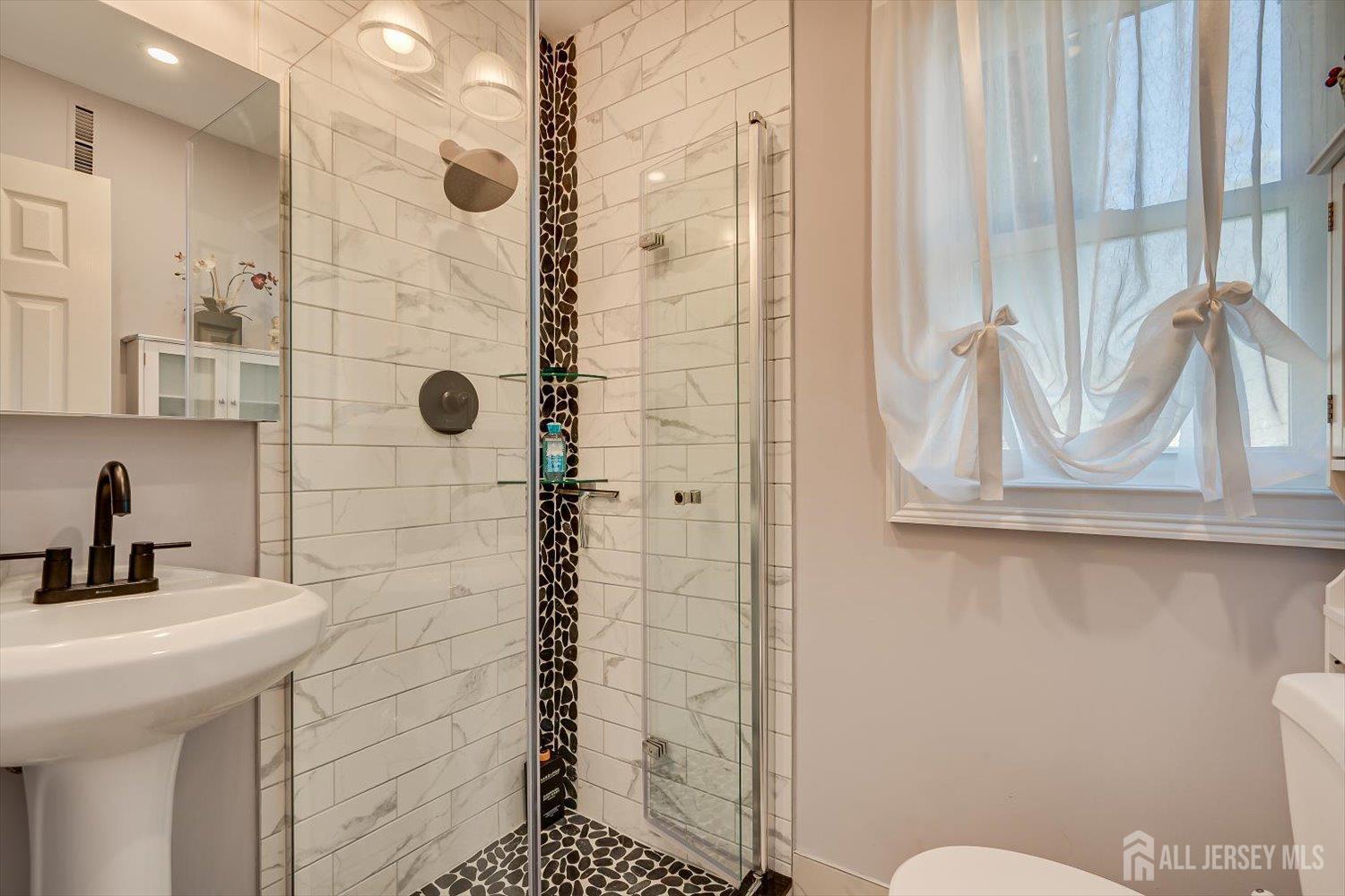 71 Crosby Avenue Edison, NJ 08817 - Photo 29 of 40 a bathroom with a sink a toilet and shower