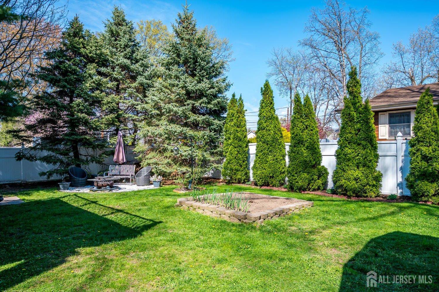 71 Crosby Avenue Edison, NJ 08817 - Photo 37 of 40 a garden with trees in front of it
