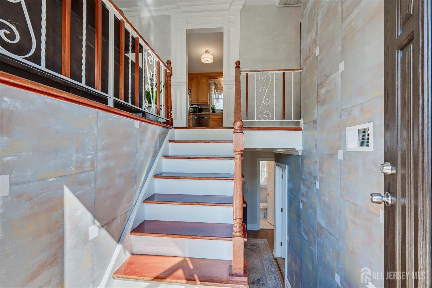 71 Crosby Avenue Edison, NJ 08817 - Photo 4 of 40 a view of staircase with lots of frames on wall and a window