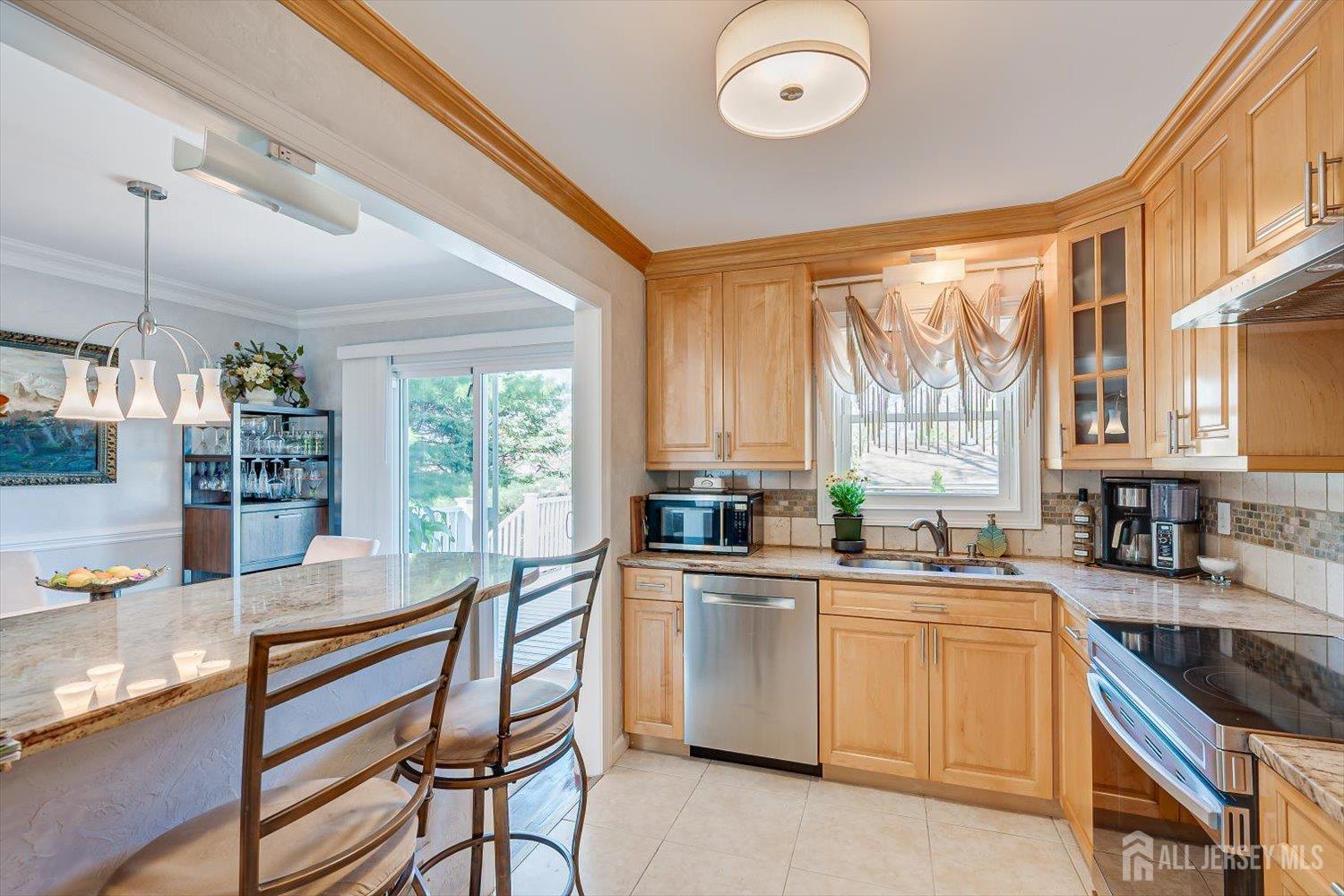 71 Crosby Avenue Edison, NJ 08817 - Photo 10 of 40 a kitchen with sink a stove and chairs