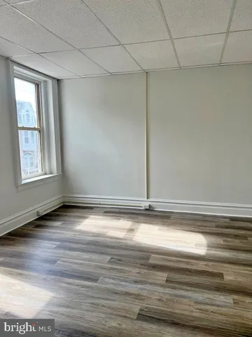 a view of a room with wooden floor and cabinet