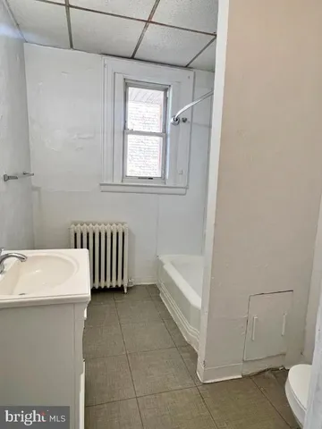 a bathroom with a sink a toilet and bathtub