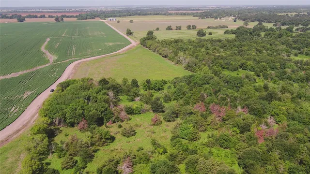 an aerial view of a residential houses with outdoor space and lake view