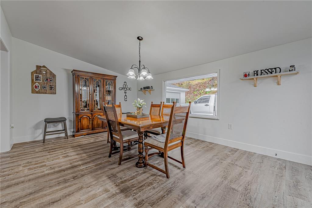 2087 White Cloud Road Leechburg, PA 15656 - Photo 7 of 25 a view of a dining room with furniture a chandelier and wooden floor