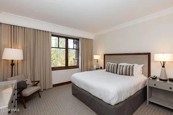 a room with pool table and a wooden floor