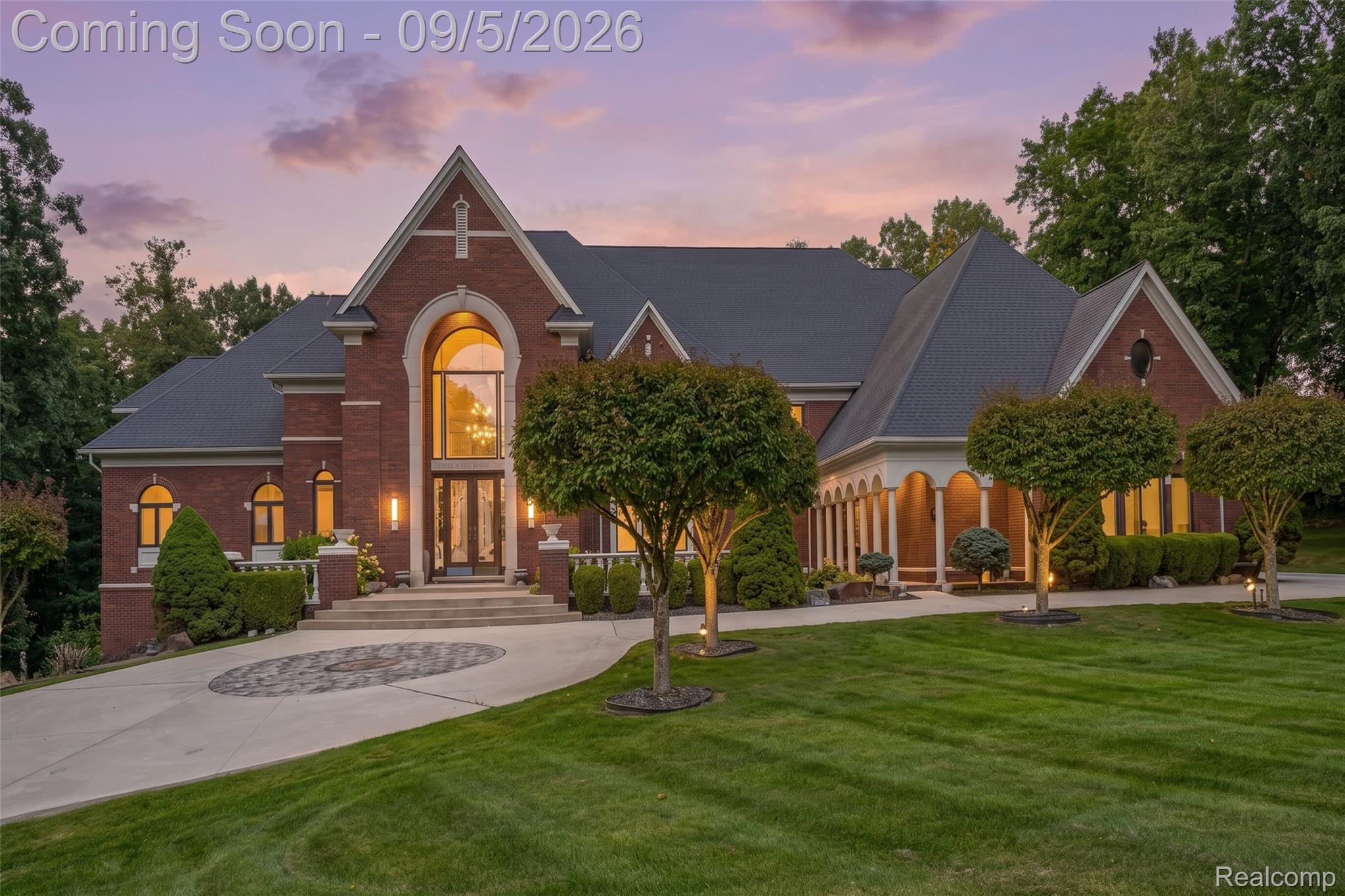 2785 Cranbrook Ridge Court Rochester, MI 48306 - Photo 1 of 97 Brick exterior with a grand arched entry, an expansive front lawn, a circular paver driveway, and a covered porch with columns