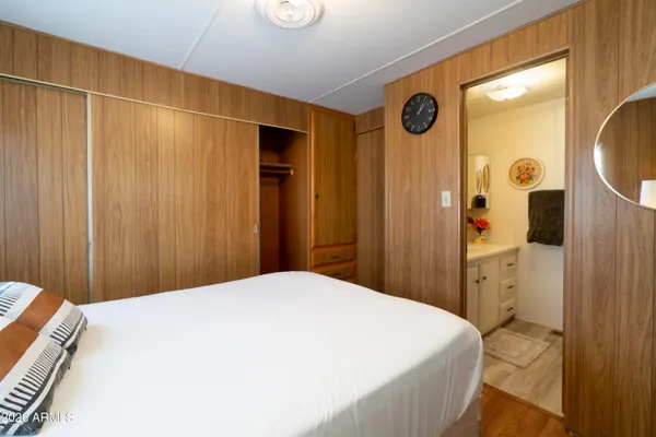 a bed room with a bed and mirror