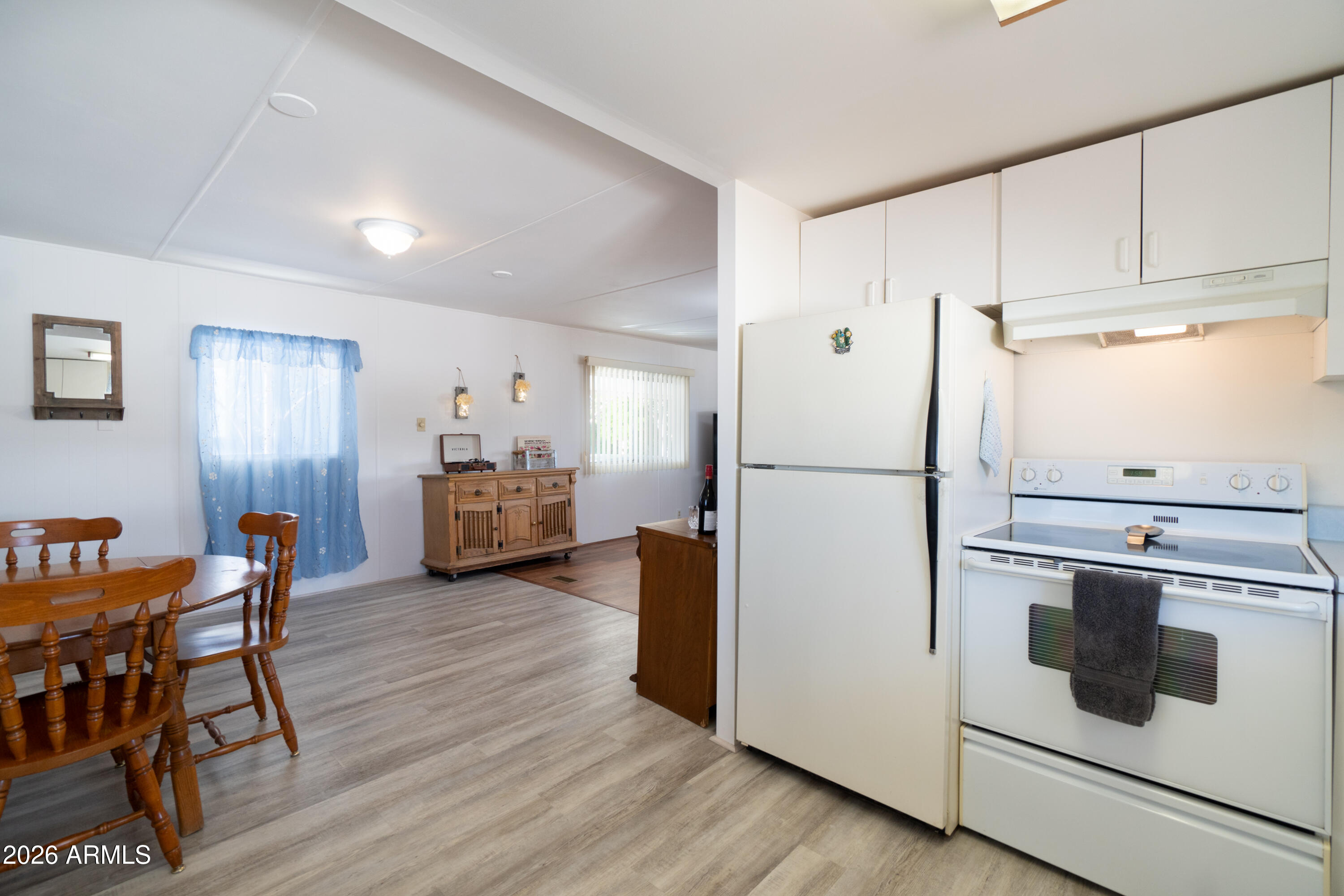 201 South Greenfield Road, Unit 361 Mesa, AZ 85206 - Photo 23 of 53 a kitchen with stainless steel appliances a refrigerator stove microwave and wooden floor