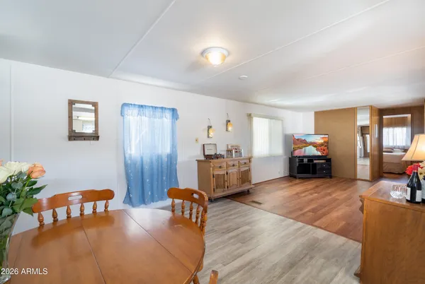 a living room with furniture dining table and wooden floor